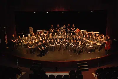 Symphonic band performing on stage.