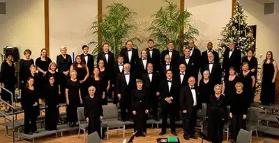 A formal group photo of a choir dressed in black attire