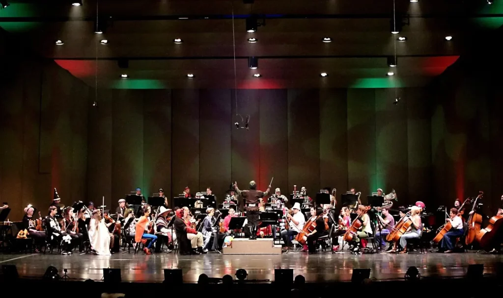 Orchestra performing in costumes on stage.
